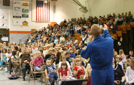 Clay Anderson speaks to crowded NBC gym.